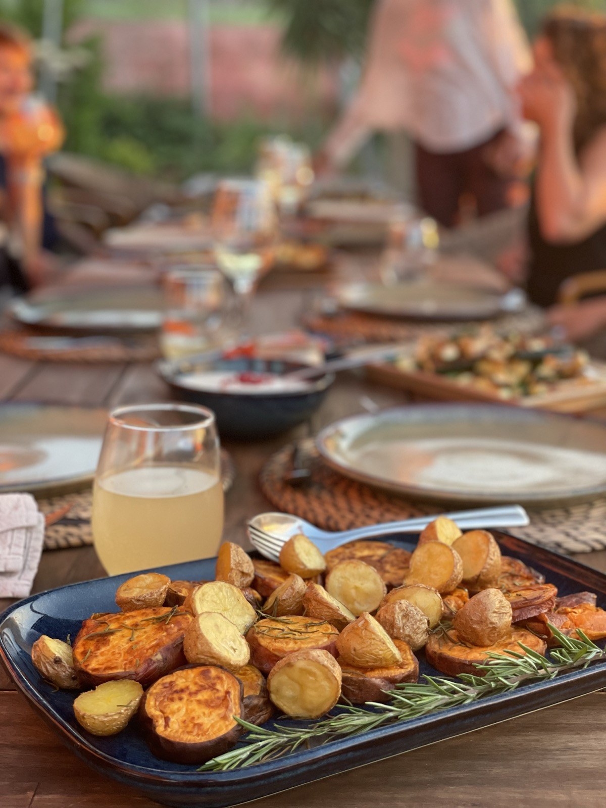 Roasted potatoes and sweet potatoes at a golden hour outdoor retreat dinner