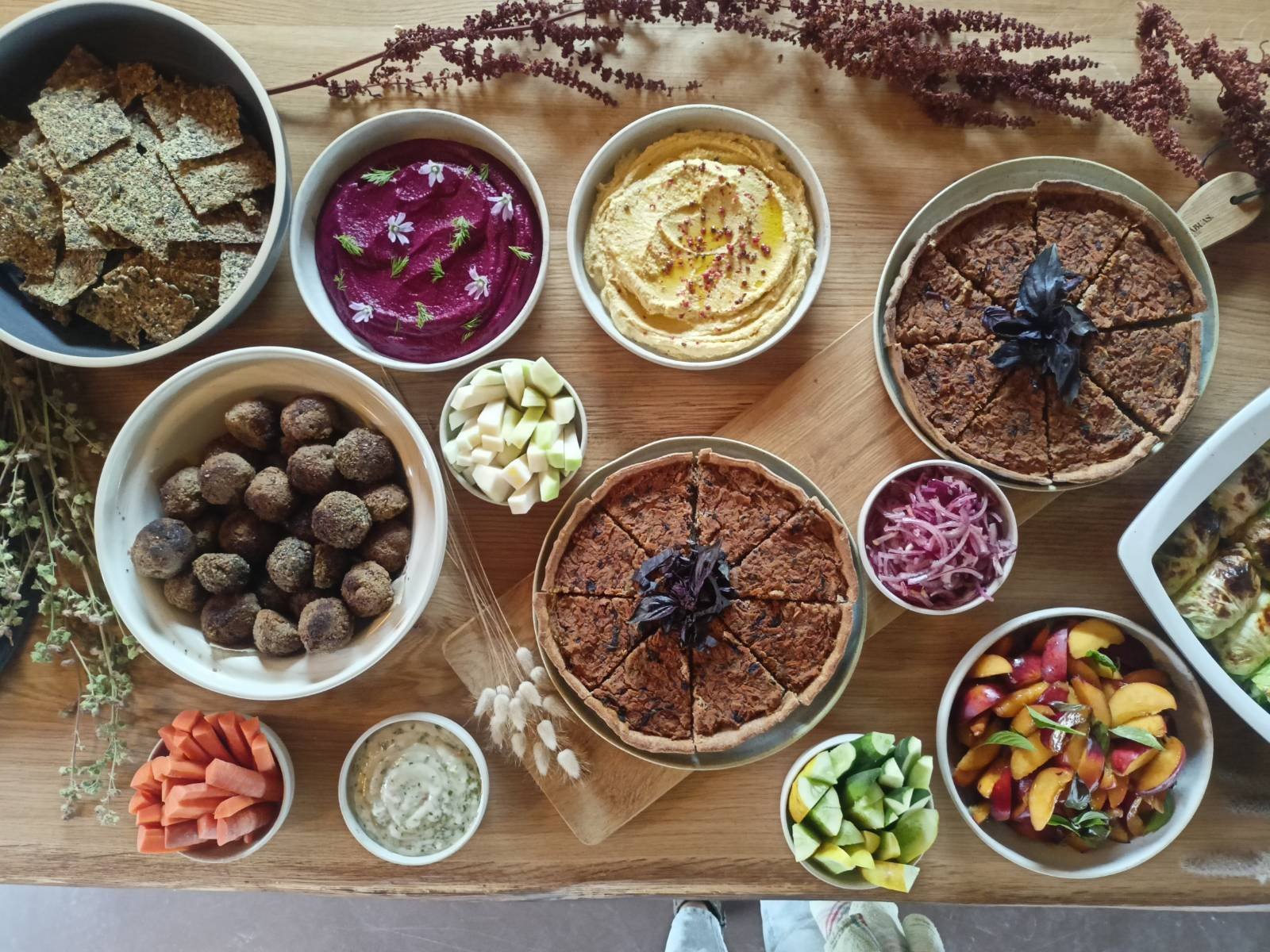 A beautiful spread of colorful plant-based dishes prepared by Skarabo Life